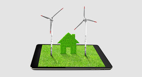 Illustration: Two wind turbines and a minature house on a green tablet screen.