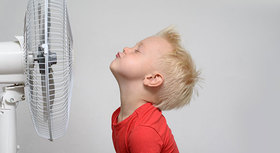 Child in front of a fan.
