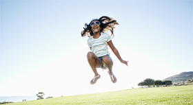 woman jumping in the air on a field